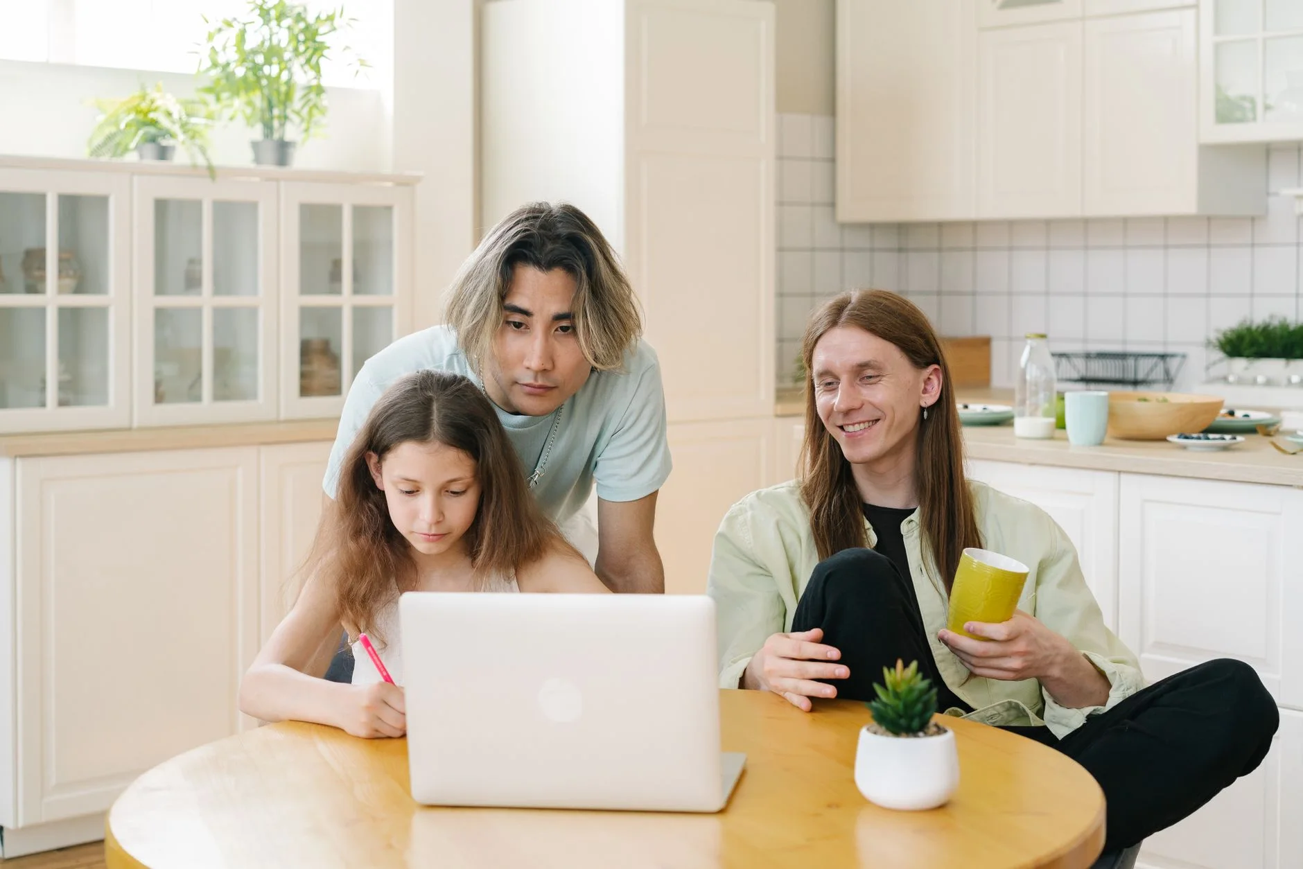 after school routine — Family of three engaged in online activities at home with a diverse setting and warm ambiance.
