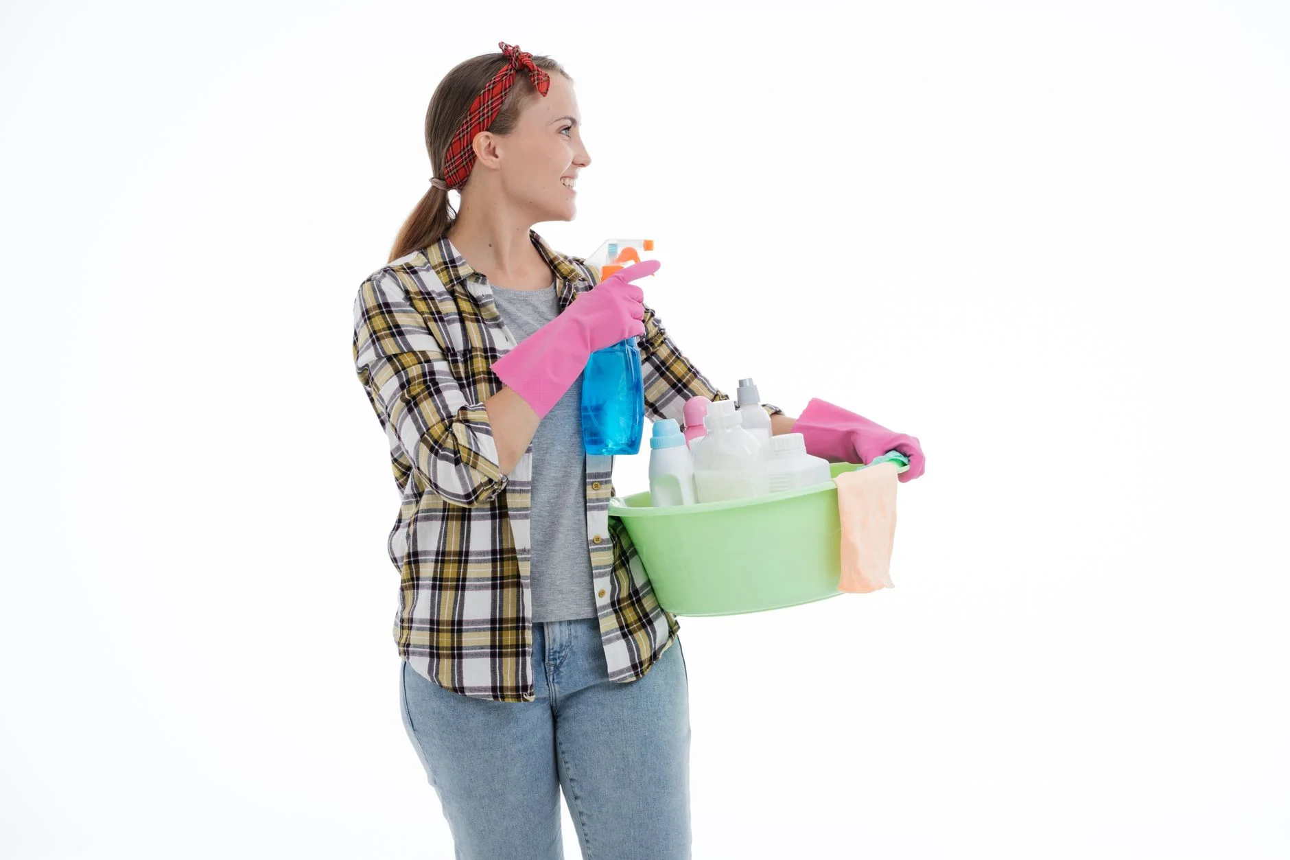 deep cleaning checklist — Woman holding cleaning supplies in a studio shot with a white background. Perfect for housekeeping themes.