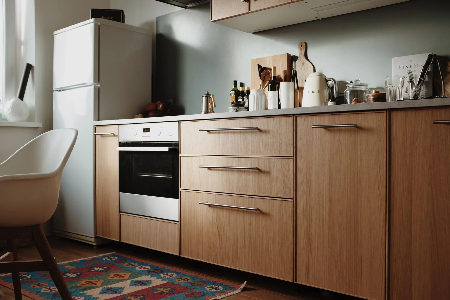 Beautiful modern kitchen featuring sleek wooden cabinets and appliances.