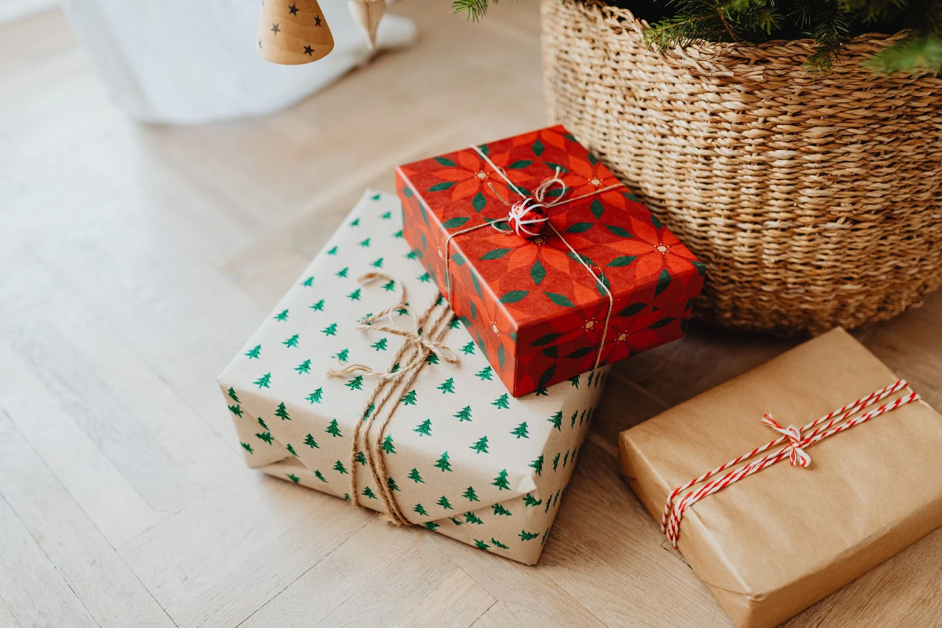 Christmas gifts wrapped in festive paper under a Christmas tree, ready for the holiday celebration.