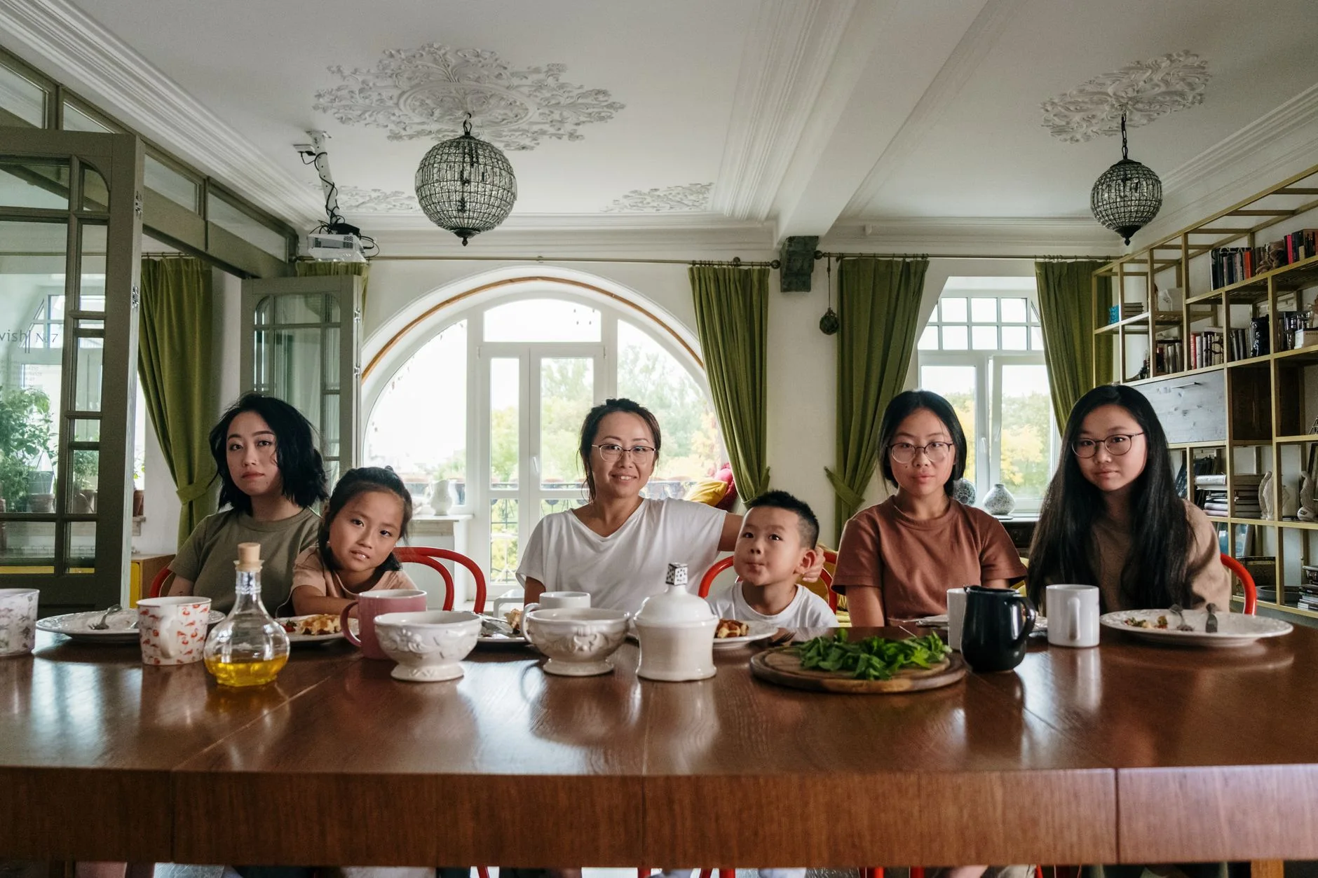 meal planning for picky eaters — A diverse family enjoying dinner together in a cozy living room setting.