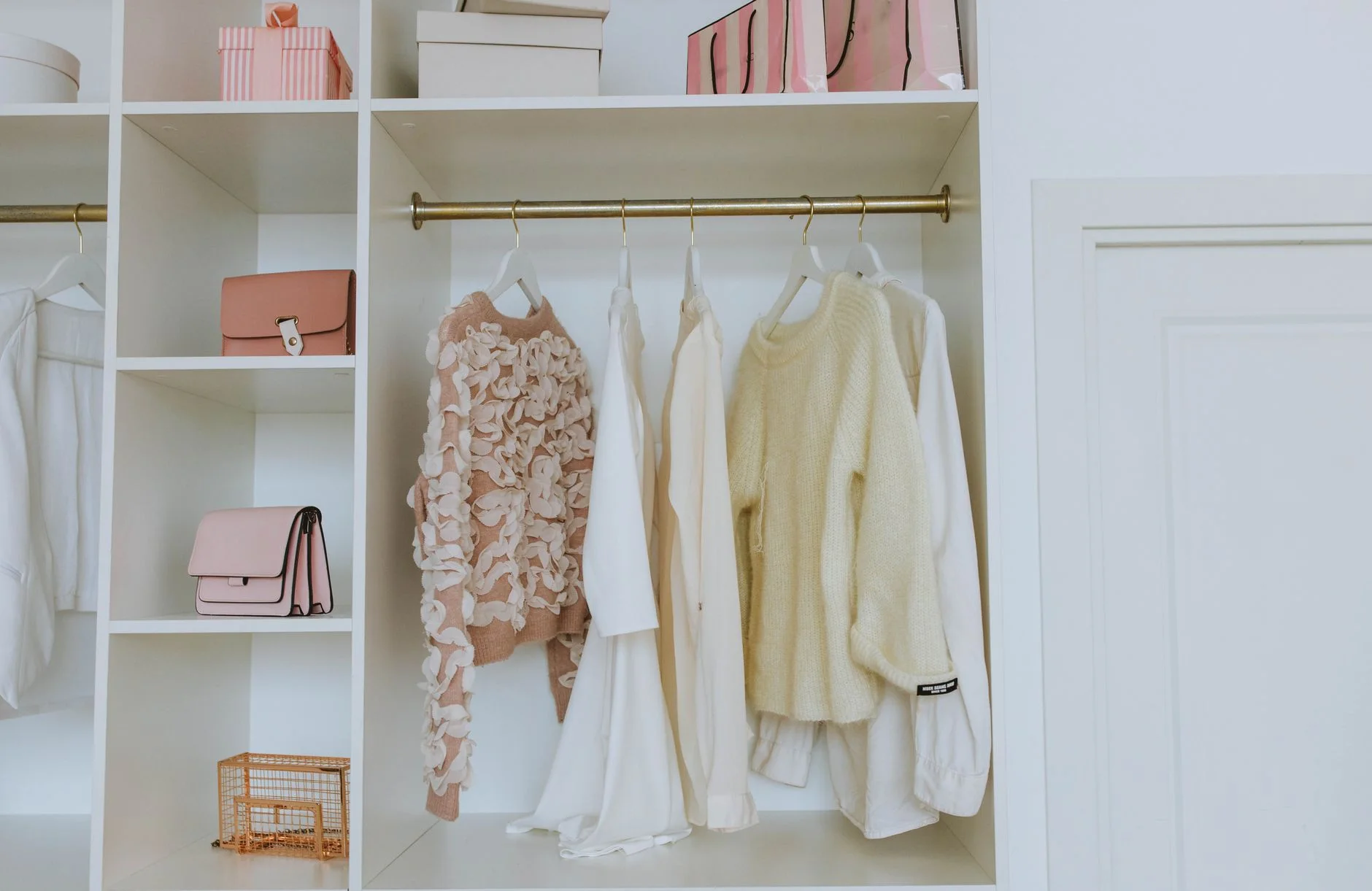 seasonal clothes storage — Neat closet showcasing white and pink clothes and accessories for a chic, clean look.