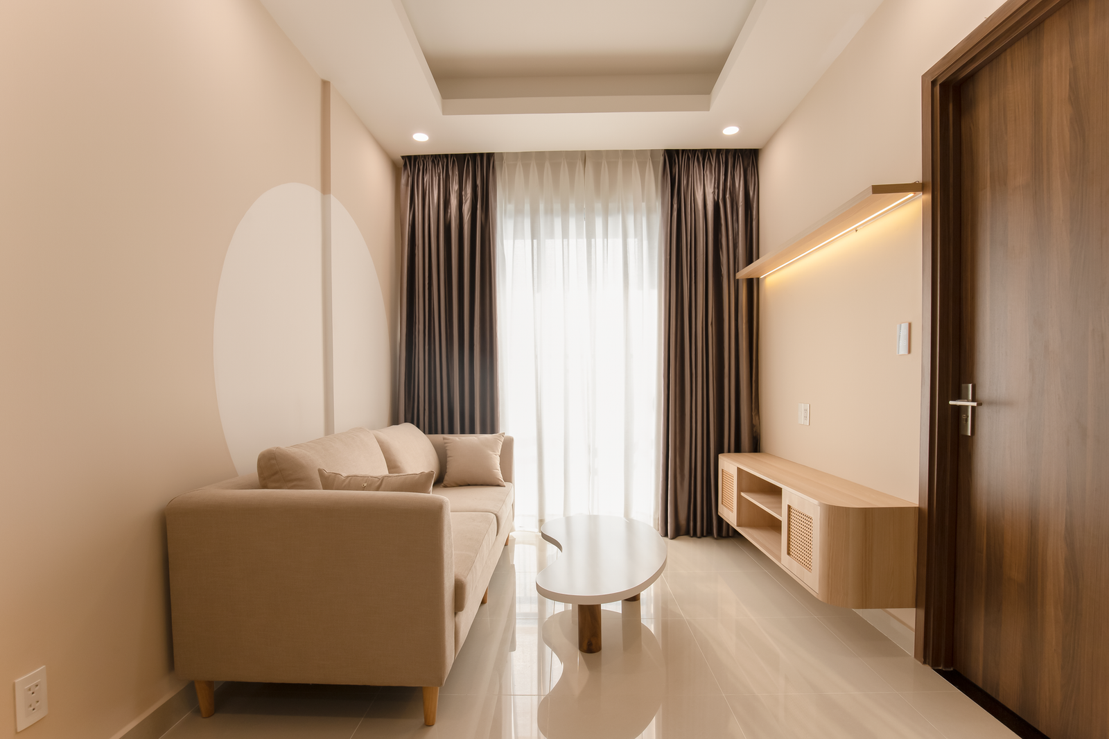 small space organization — A minimalist living room with a beige sofa, modern table, and soft lighting.