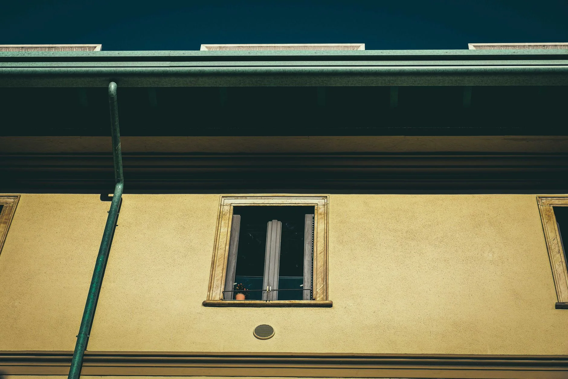 winterize your home — From below of aged dwelling building exterior with window on front wall in city in sunlight
